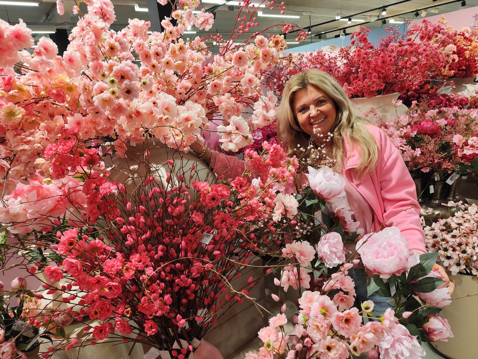 Nance surrounded by her beautiful silk flower creations